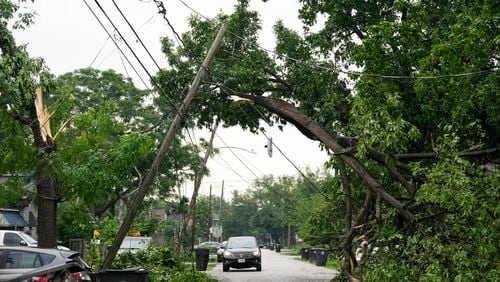 A tree snapped and tangled with the power wires on Gentry Street on Friday, May 17, 2024 in Northeast Houston. (Yi-Chin Lee/Houston Chronicle via AP)