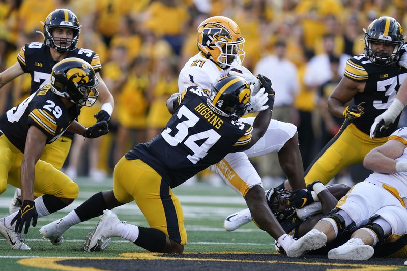 FILE - Kent State running back Joachim Bangda (21) is tackled by Iowa linebacker Jay Higgins (34) during the second half of an NCAA college football game, Saturday, Sept. 18, 2021, in Iowa City, Iowa. (AP Photo/Charlie Neibergall, File)