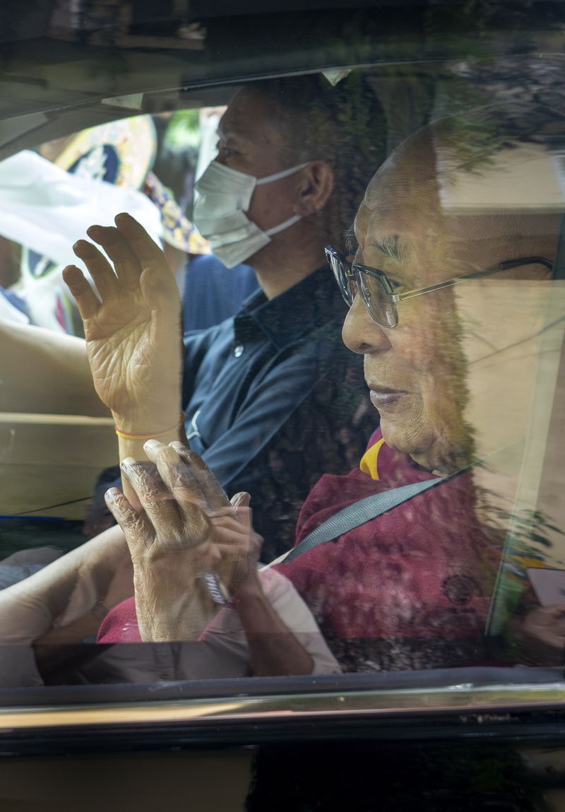 Tibetan spiritual leader the Dalai Lama greets a welcoming crowd from inside his car as he arrived in Dharamshala, India, Wednesday, Aug. 28, 2024. (AP Photo/Ashwini Bhatia)