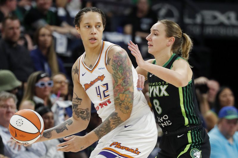 Phoenix Mercury center Brittney Griner (42) works around Minnesota Lynx forward Alanna Smith (8) in the first quarter of Game 2 of a WNBA basketball first-round playoff game, Wednesday, Sept. 25, 2024, in Minneapolis. (AP Photo/Bruce Kluckhohn)