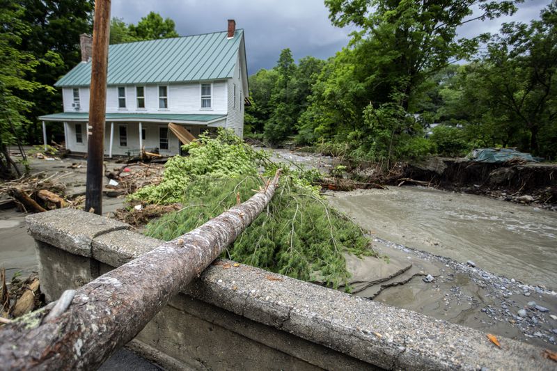 Debris is strewn about a damaged bridge over the Winooski River following flooding caused by the remnants of Hurricane Beryl, Thursday, July 11, 2024, in Plainfield, Vt. (AP Photo/Dmitry Belyakov)