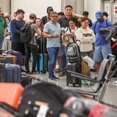 A meltdown of Delta flight operations continued Monday, July 22, 2024, and passengers waited in long lines at Hartsfield-Jackson International Airport trying to retrieve their checked bags and get customer service help. (John Spink / John.Spink@ajc.com)