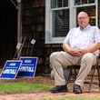 The Rev. Brant Kennedy, the first vice chair of the Washington County Republican Party, poses for a portrait in front of his home in Sandersville. Trump signs lean on a wall for local Republicans to pick up. (Seeger Gray / AJC)