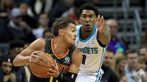 Malik Monk of the Charlotte Hornets tries to stop Trae Young #11 of the Atlanta Hawks during their game at Spectrum Center on December 08, 2019 in Charlotte, North Carolina.