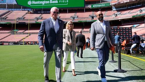 Cleveland Browns owners Jimmy Haslam, left, and Dee,Haslam, center, walk with Peter John-Baptiste, right, Browns vice president of communications, right, as the team announces that Cleveland Browns Stadium will now be called Huntington Bank Field, during an NFL football news conference, Tuesday, Sept. 3, 2024, in Cleveland. (AP Photo/Sue Ogrocki)