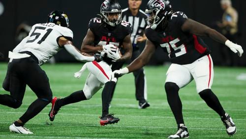 Atlanta Falcons running back Spencer Brown (42) runs against Jacksonville Jaguars linebacker Ventrell Miller (51) as Atlanta Falcons offensive tackle Jaryd Jones-Smith (75) blocks during their preseason NFL game at Mercedes-Benz Stadium, on Friday, Aug. 23, 2024, in Atlanta. The Falcons lost 31-0. (Jason Getz / AJC)
