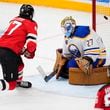 New Jersey Devils' Paul Cotter scores his sides second goal past Buffalo Sabres' Devon Levi during the NHL hockey game between Buffalo Sabres and New Jersey Devils, in Prague, Czech Republic, Saturday, Oct. 5, 2024. (AP Photo/Petr David Josek)