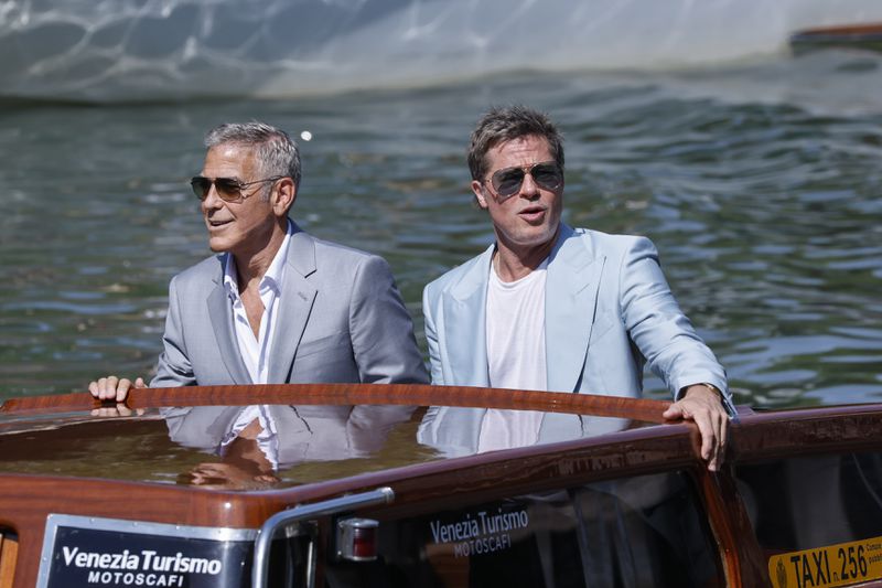 George Clooney, left, and Brad Pitt upon arrival for the press conference of the film 'Wolfs' during the 81st edition of the Venice Film Festival in Venice, Italy, on Sunday, Sept. 1, 2024. (Photo by Joel C Ryan/Invision/AP)