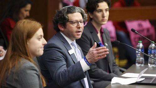 Rabbi Larry Sernovitz, with two college students, speaks Monday in favor of an antisemitism bill, House Bill 30, during public comment at the Senate Judiciary Committee. HB 30 passed unanimously. (Jason Getz/jason.getz@ajc.com)