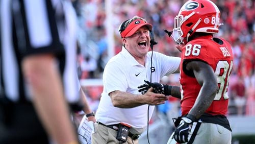 Georgia wide receiver Dillon Bell (86) is congratulated by head coach Kirby Smart after scoring a touchdown during the second half in an NCAA football game at Sanford Stadium, Saturday, October 5, 2024, in Athens. Georgia won 31-13 over Auburn. (Hyosub Shin / AJC)