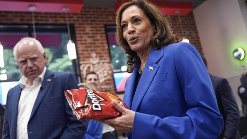 FILE - Democratic presidential nominee Vice President Kamala Harris holds a bag of Doritos chips as Democratic vice presidential nominee Minnesota Gov. Tim Walz looks on at Sheetz convenience store during a campaign stop, Aug. 18, 2024, in Coralpolis, Pa. (AP Photo/Julia Nikhinson, File)