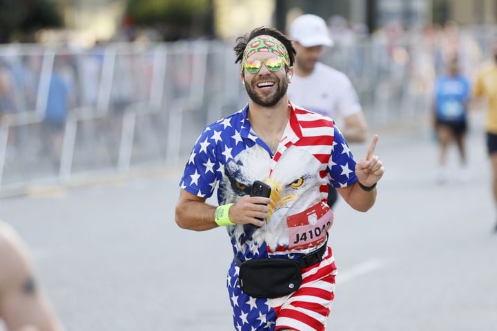 Peachtree runner shows patriotic spirit at the start of the 55th running of the Atlanta Journal-Constitution Peachtree Road Race in Atlanta on Thursday, July 4, 2024.   (Miguel Martinez / AJC)