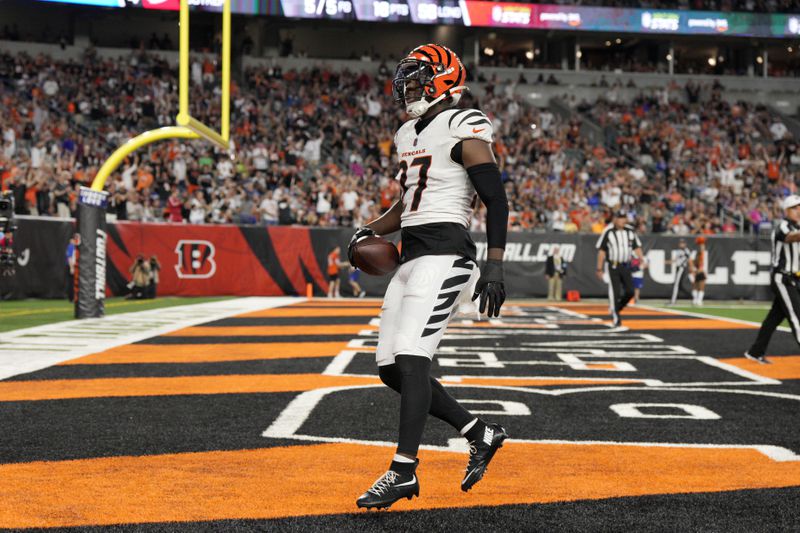 Cincinnati Bengals safety Jordan Battle (27) celebrates after returning an interception for a touchdown during the first half of a preseason NFL football game against the Indianapolis Colts, Thursday, Aug. 22, 2024, in Cincinnati. (AP Photo/Jeff Dean)