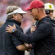 Georgia head coach Kirby Smart, left, and Alabama head coach Kalen DeBoer meet at midfield before an NCAA college football game, Saturday, Sept. 28, 2024, in Tuscaloosa, Ala. (AP Photo/Vasha Hunt)