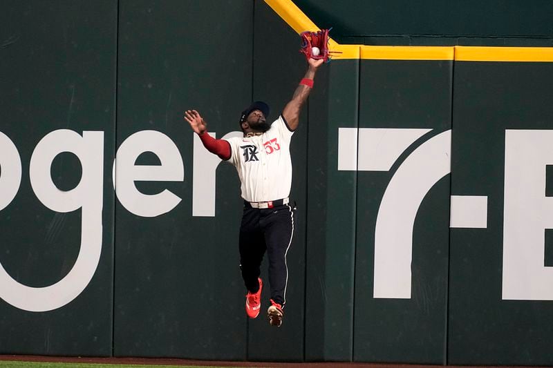 Texas Rangers right fielder Adolis Garcia makes a leaping catch on a fly out by Los Angeles Angels' Nolan Schanuel in the first inning of a baseball game, Friday, Sept. 6, 2024, in Arlington, Texas. (AP Photo/Tony Gutierrez)