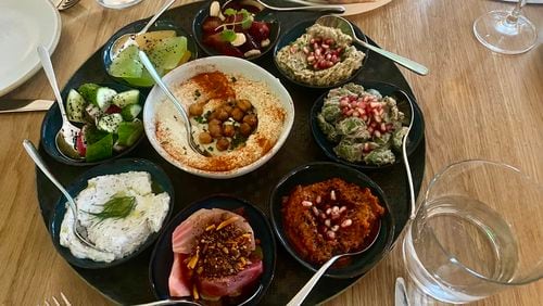 The mezze platter at Elektra includes a selection of spreads and dips, as well as a chef's choice of chilled vegetable and fruit preparations. (Ligaya Figueras/AJC)