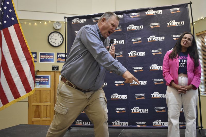 U.S. Sen. Jon Tester, D-Mont., leads a cheer at a rally with Planned Parenthood Action Fund President Alexis McGill Johnson, Thursday, Sept. 5, 2024, in Bozeman, Mont. (AP Photo/Matthew Brown)