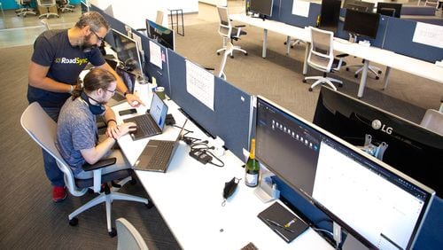 RoadSync employees Ivan Zhelezarov (L) and Alex Petralia work in the company's new office space in Atlanta. RoadSync and other companies are beginning to commit to having employees return to work by signing new office leases.  STEVE SCHAEFER FOR THE ATLANTA JOURNAL-CONSTITUTION