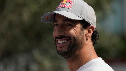 RB driver Daniel Ricciardo of Australia smiles in the paddock at the Baku circuit, in Baku, Azerbaijan, Thursday, Sept.12, 2024. The Formula One Grand Prix will be held on Sunday. (AP Photo/Sergei Grits)