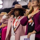 Shirlene C. Olson salutes during the national anthem at Fiserv Forum in Milwaukee on Wednesday, July 17, 2024, the third day of the Republican National Convention. (Arvin Temkar / AJC)