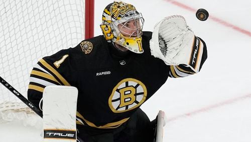 FILE - Boston Bruins' Jeremy Swayman makes a glove save during the third period in Game 6 of an NHL hockey Stanley Cup second-round playoff series against the Florida Panthers, May 17, 2024, in Boston. (AP Photo/Michael Dwyer, File)