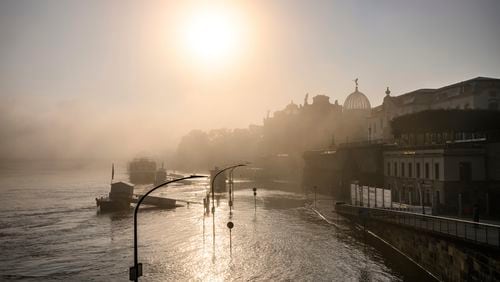 A view of the Terrassenufer in the Old Town is flooded by the high water of the Elbe in the morning fog, in Dresden, Germany, Wednesday, Sept. 18, 2024. (Robert Michael/dpa via AP)