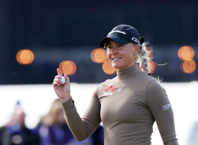 England's Charley Hull reacts to the crowd at the 3rd green during the third round of the Women's British Open golf championship, in St Andrews, Scotland Saturday, Aug. 24, 2024. (AP Photo/Scott Heppell)