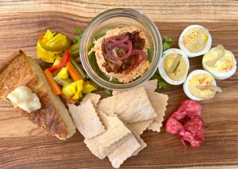 The pimento cheese board at Kindred comes with sourdough crackers, deviled eggs, house-made pickles, bacon jam and a slice of cornbread. Courtesy of Rebecca Cochran