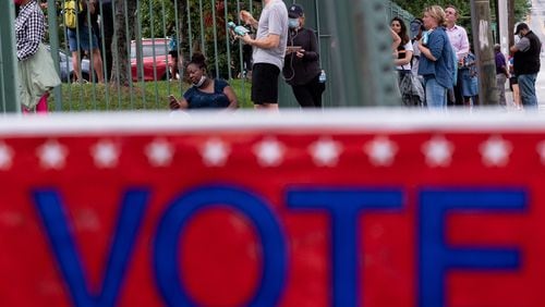 Voters wait in line at the Fanplex voting site late Tuesday evening June 9, 2020, across from the old Turner Field in Atlanta. Voters were reporting a three-hour wait at the site. Ben Gray for the Atlanta Journal-Constitution