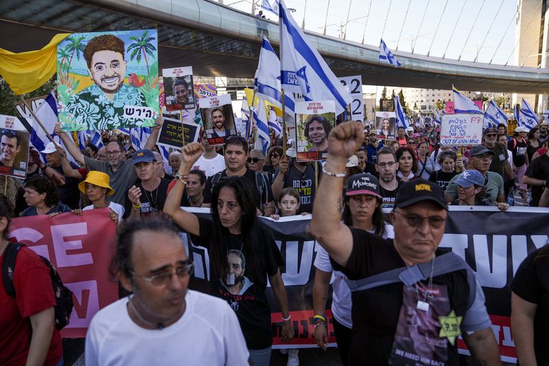 Family members and supporters of the hostages held captive by Hamas in Gaza complete the final leg of a four-day march from Tel Aviv to Jerusalem to demand the immediate release of all hostages in Jerusalem on Saturday, July 13, 2024. (AP Photo/Mahmoud Illean)