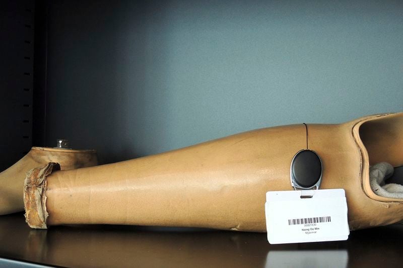 A couple of old prosthetics lay on a shelf at the Ottobock repair center in the Paralympic Village in Saint-Denis, near Paris, France, Saturday, Aug. 24, 2024. (AP Photo/Tom Nouvian)