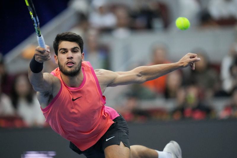 Carlos Alcaraz of Spain returns a shot from Jannik Sinner of Italy during their men's singles finals match of the China Open tennis tournament, at the National Tennis Center in Beijing, Wednesday, Oct. 2, 2024. (AP Photo/Achmad Ibrahim)