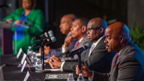 Clayton County sheriff candidates (from left) Clarence Cox, Terry Evans, Dwayne Fabian and Chris Storey debate at Tabernacle of Praise Church International in Jonesboro on Tuesday. (Jenni Girtman for Atlanta Journal-Constitution)