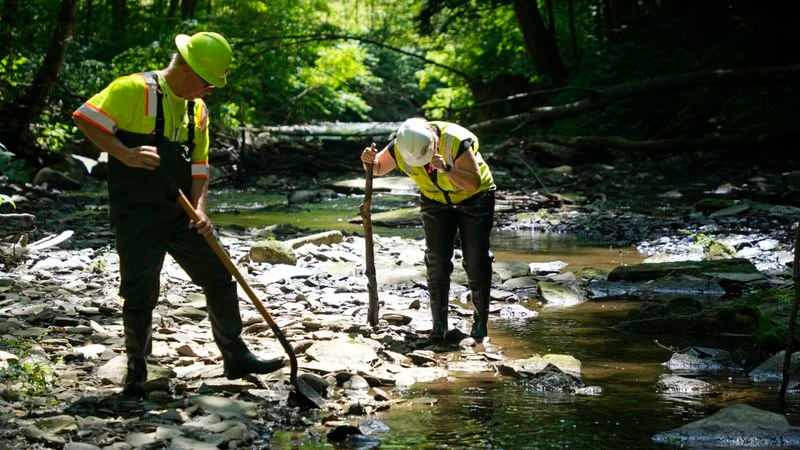 FILE - Environmental Protection Agency workers work in Leslie Run in East Palestine, Ohio, June 12, 2024. (AP Photo/Gene J. Puskar, File)