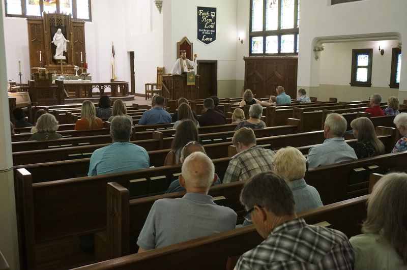 The Rev. Dustin Haider preaches to the congregation during Sunday service at Holden Lutheran Church, where many in the pews are descendants of the Norwegian families who first established the church in the mid-19th century, near Kenyon, Minn, on Sept. 1, 2024. (AP Photo/Giovanna Dell'Orto)