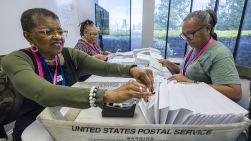 FILE - From left, Carol Hamilton, Cristo Carter and Cynthia Huntley prepare ballots to be mailed at the Mecklenburg County Board of Elections in Charlotte, N.C., Sept. 5, 2024. (AP Photo/Nell Redmond, File)