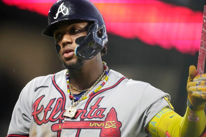 Ronald Acuna Jr. tackled by fan at Coors Field during Rockies-Braves