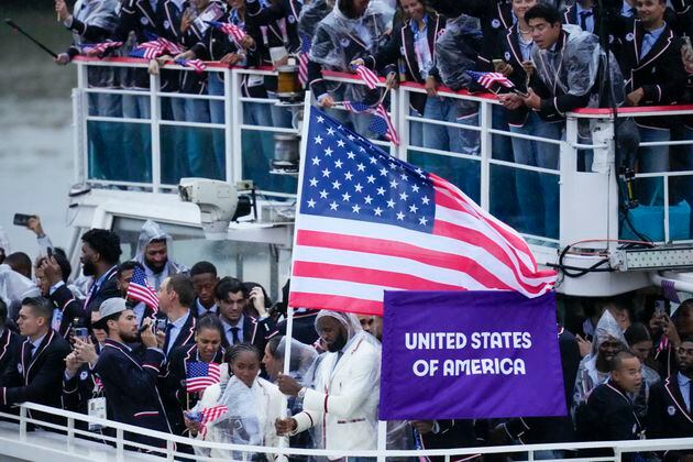 United States' Coco Gauff and Lebron James, bottom center, travel with teammates along the Seine River in Paris, France, during the opening ceremony of the 2024 Summer Olympics, Friday, July 26, 2024. (AP Photo/Kirsty Wigglesworth)