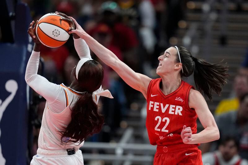 Phoenix Mercury's Kahleah Copper (2) is fouled by Indiana Fever's Caitlin Clark (22) during the second half of a WNBA basketball game, Friday, Aug. 16, 2024, in Indianapolis. (AP Photo/Darron Cummings)