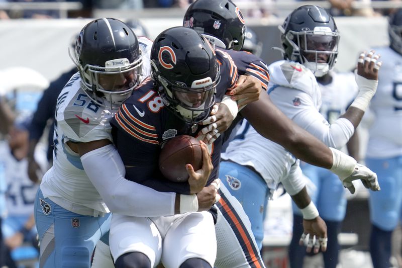 Tennessee Titans linebacker Harold Landry III, left, sacks Chicago Bears quarterback Caleb Williams during the second half of an NFL football game Sunday, Sept. 8, 2024, in Chicago. (AP Photo/Nam Y. Huh)