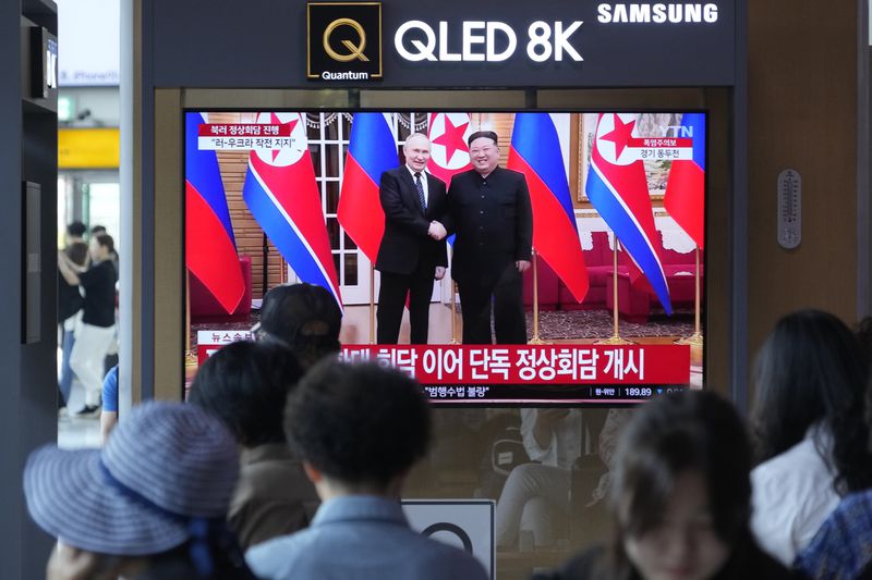 A TV screen shows an image of North Korean leader Kim Jong Un, right, and Russian President Vladimir Putin during a news program, at the Seoul Railway Station in Seoul, South Korea, Wednesday, June 19, 2024. North Korean leader Kim promised full support for Russia's war in Ukraine before beginning a one-on-one meeting with Russian President Putin in Pyongyang on Wednesday, in a bid to expand their economic and military cooperation and show a united front against Washington. (AP Photo/Ahn Young-joon)