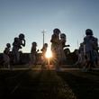 The sun sets as Seckinger football players run to return to their locker room briefly before their game against Roswell at Roswell High School, Friday, Sept. 20, 2024, in Roswell, Ga. (Jason Getz / AJC)

