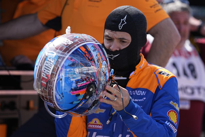 Kyle Larson puts on his helmet during a practice session for the Indianapolis 500 auto race at Indianapolis Motor Speedway, Friday, May 24, 2024, in Indianapolis. (AP Photo/Darron Cummings)