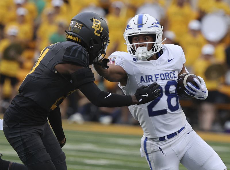 Air Force running back Aiden Calvert stiff-arms Baylor linebacker Keaton Thomas while running toward the sidelines during the first half of an NCAA college football game, Saturday, Sept. 14, 2024, in Waco, Texas. (Rod Aydelotte/Waco Tribune-Herald via AP)