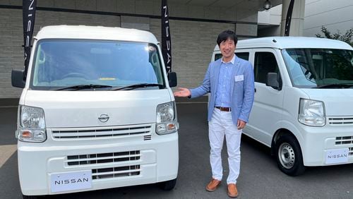 Susumu Miura, a Nissan Research Center manager, shows a Nissan car that is coated with the special “cool paint,” under testing at Tokyo’s Haneda airport Tuesday, Aug. 6, 2024. (AP Photo/Yuri Kageyama)