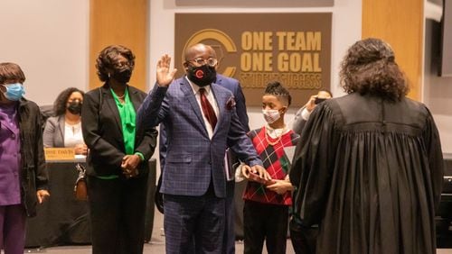 New Cobb County Board of Education member Leroy "Tre" Hutchins takes his oath of office issued by Superior Court Judge Kellie Hill during a called meeting on Thursday. Credit: Cobb County School District.