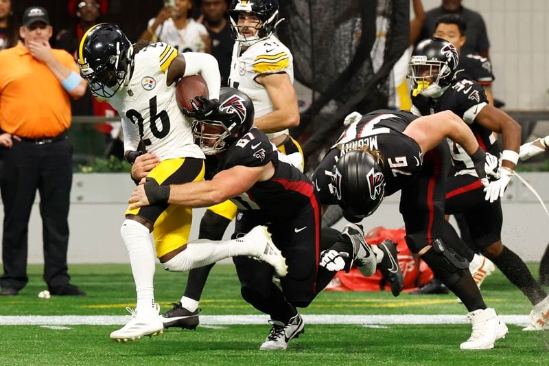 Pittsburgh Steelers cornerback Donte Jackson (26) is tackled by Atlanta Falcons center Drew Dalman (67) after an interception during the second half of an NFL football game Sunday, Sept. 8, 2024, in Atlanta. (AP Photo/Butch Dill)