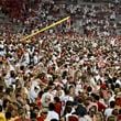 Arkansas fans rush the field to celebrate after Arkansas upsets Tennessee 19-14 during an NCAA college football game, Saturday, Oct. 5, 2024, in Fayetteville, Ark. (AP Photo/Michael Woods)