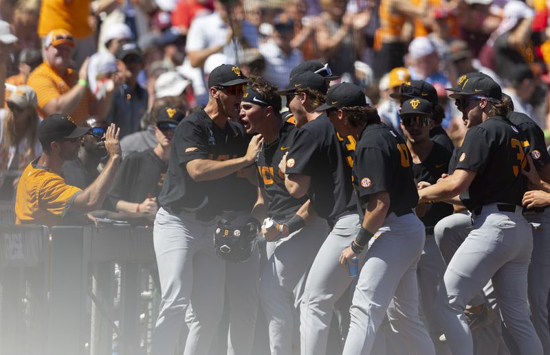 Tennessee's Dylan Dreiling, third left, celebrates with teammates after hitting a two-run home run to take the lead against Texas A&M in the seventh inning of Game 2 of the NCAA College World Series baseball finals in Omaha, Neb., Sunday, June 23, 2024. (AP Photo/Rebecca S. Gratz)