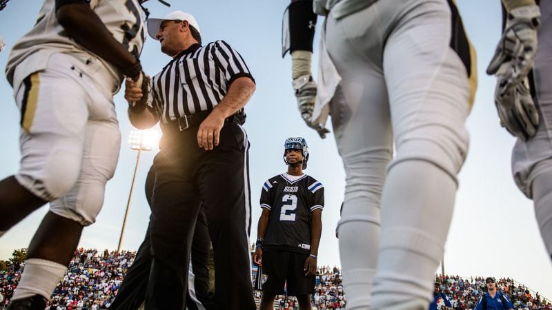 Jaylend Ratliffe of Scotland County (N.C.) High School attends a Georgia Tech game. An accident kept Ratliffe off the field. When he was allowed back on the sideline he had to wear a special helmet in case there was a sideline collision.